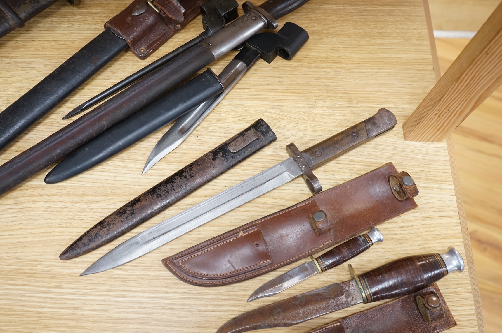 A 1907 bayonet by Wilkinson in its steel mounted leather scabbard, another similar with leather frog, two small British bayonets, a Continental bayonet, and two assorted hunting knives (7)